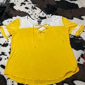 Rue 21 yellow top with cross cross design on the front.
